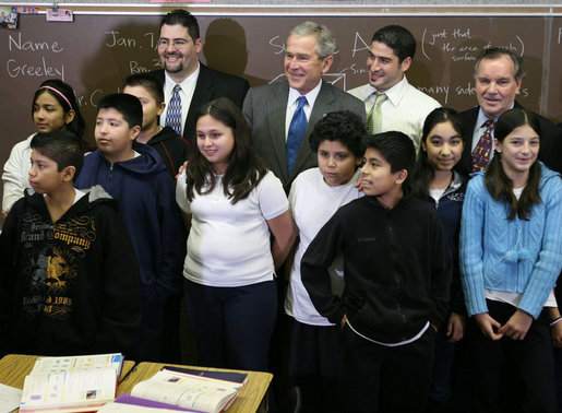 President George W. Bush is joined by Principal Carlos Azcoitia, left; teacher Rene Camler and Chicago Mayor Richard M. Daley, right, Monday, Jan. 7, 2008, during a visit with students and staff at the Horace Greeley Elementary School in Chicago. White House photo by Joyce N. Boghosian