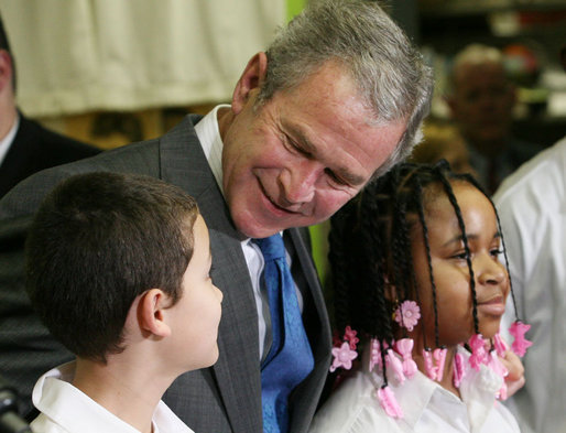 President George W. Bush talks with sixth grade student Mariano Ramos, 11, left, and seventh grader Amber McCarthy, 12, Monday, Jan. 7, 2008, during a visit to the Horace Greeley Elementary School in Chicago. White House photo by Joyce N. Boghosian