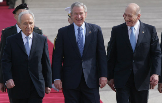 President George W. Bush and Israel’s Prime Minister Ehud Olmert smile as they join Israeli President Shimon Peres for arrival ceremonies Wednesday, Jan. 9, 2008, after President Bush’s arrival in Tel Aviv. White House photo by Chris Greenberg