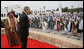 President George W. Bush enjoys the moment with performers Saturday, Jan. 12, 2008, after being presented with a sword by King Hamad Bin Isa Al-Khalifa, left, during arrival ceremonies in Manama, Bahrain. White House photo by Eric Draper