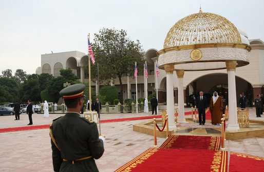 President George W. Bush and President Sheikh Khalifa bin Zayed Al Nahyan of the United Arab Emirates, stand for their national anthems Sunday, Jan. 13, 2008, during arrival ceremonies for President Bush in the courtyard of Al Mushref Palace in Abu Dhabi. White House photo by Eric Draper