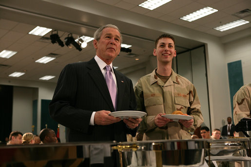 President George W. Bush stands with SN Kevin Key of Wisconsin during breakfast Sunday with military personnel and coalition forces at the U.A Naval Forces Central Command in Manama, Bahrain. White House photo by Chris Greenberg