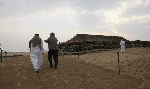 President George W. Bush and Crown Prince Sheikh Mohammed bin Zayed Al Nayhan walk a path in the desert prior to dinner Sunday, Jan. 13, 2008, near Abu Dhabi. White House photo by Eric Draper