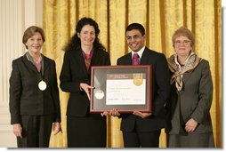 Mrs. Laura Bush along with Dr. Anne Radice, the Director of the Institute of Museum and Library Services, right, presents a 2007 National Awards for Museum and Library Services awards to both Nancy Stueber, Director, and Priyam Shah, Community Representative of the Oregon Museum of Science & Industry, Portland, OR, during a ceremony in the East Room at the White House Monday, January 14, 2008. "Regular visitors to OMSI can touch a tornado, uncover a fossil, experience an earthquake, visit the Northwest's largest planetarium, explore a Navy submarine, or just experiment on their own in one of eight hands-on labs." Mrs. Bush said of the Oregon Museum of Science & Industry during her remarks.  White House photo by Shealah Craighead