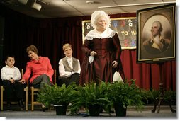 Ms. Mary Wiseman, Martha Washington Re-enactor, Mount Vernon Estate and Gardens, leads Mrs. Laura Bush, Santiago Echeverria, Student, and Dr. Tish Howard, Principal, Washington Mill Elementary School, in a ceremony at Washington Mill Elementary School Tuesday, January 15, 2008, in Alexandria, Virginia, to celebrate Mount Vernon's "George Washington's Return to School" program. The “Portrait of Leadership” initiative was planned to coincide with the 275th birthday year of George Washington, celebrated in February of 2007, to help put a portrait of George Washington in class rooms in all fifty states.  White House photo by Shealah Craighead