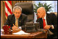 President George W. Bush speaks via conference call to Bicameral and Bipartisan leadership Thursday, Jan. 17, 2008, from the Oval Office of the White House. With him is Secretary of the Treasury Hank Paulson. White House photo by Joyce N. Boghosian