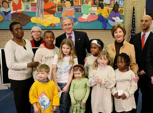 President George W. Bush and Laura Bush are joined by Washington, D.C. Mayor Adrian Fenty, right, and Ginnie Cooper, Chief Librarian for the Washington, D.C. libraries, left, posing for photos with children and staff at a reading class commemorating Martin Luther King, Jr., Day Monday, Jan. 21, 2008, at the Martin Luther King, Jr., Memorial Library. White House photo by Eric Draper