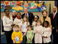 President George W. Bush and Laura Bush are joined by Washington, D.C. Mayor Adrian Fenty, right, and Ginnie Cooper, Chief Librarian for the Washington, D.C. libraries, left, posing for photos with children and staff at a reading class commemorating Martin Luther King, Jr., Day Monday, Jan. 21, 2008, at the Martin Luther King, Jr., Memorial Library. White House photo by Eric Draper