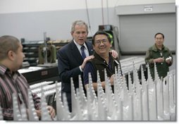 President George W. Bush speaks with assembly workers on his tour of the Robinson Helicopter Company Wednesday, Jan. 30, 2008 in Torrance, Calif. White House photo by Eric Draper