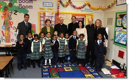 Mrs. Laura Bush accompanied by Archbishop of Washington, D.C.Donald W. Wuerl, pose for a photo with staff and students of Holy Redeemer School Wednesday, Jan. 30.2008, in Washington, D.C. White House photo by Shealah Craighead