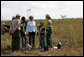 Mrs. Laura Bush joins Florida City Elementary School students Cornesha Dericho, left, and Dania Amaya, along with park ranger Allyson Gantt, right, as they prepare to plant a Gumbo Limbo tree Wednesday, Feb. 6, 2008, during the Junior Ranger "First Bloom" planting event in Everglades National Park, Fla. Mrs. Bush praised the Everglades restoration program which hopes to plant native trees to replace invasive species that are choking the park. White House photo by Shealah Craighead