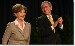 President George W. Bush smiles as Mrs. Laura Bush is introduced Thursday, Feb. 7, 2008, during the National Prayer Breakfast at the Washington Hilton Hotel. White House photo by Joyce N. Boghosian