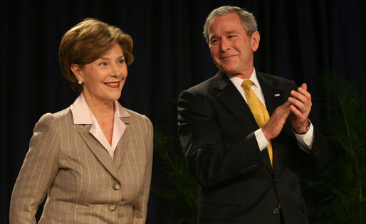 President George W. Bush smiles as Mrs. Laura Bush is introduced Thursday, Feb. 7, 2008, during the National Prayer Breakfast at the Washington Hilton Hotel. White House photo by Joyce N. Boghosian