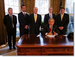 President George W. Bush speaks to the press after the signing of the 2008 Economic Report Monday Feb. 11, 2008, in the Oval Office. Joining President Bush are, from left, Chuck Blahous, Deputy Assistant to the President for Economic Policy; Pierce Scranton, Chief of Staff, Council of Economic Advisors; Eddie Lazear, Chairman, Council of Economic Advisors; Donald Marron, Senior Economic Advisor, Council of Economic Advisors; and Keith Hennessey, Assistant to the President for Economic Policy.  White House photo by Joyce N. Boghosian