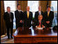 President George W. Bush speaks to the press after the signing of the 2008 Economic Report Monday Feb. 11, 2008, in the Oval Office. Joining President Bush are, from left, Chuck Blahous, Deputy Assistant to the President for Economic Policy; Pierce Scranton, Chief of Staff, Council of Economic Advisors; Eddie Lazear, Chairman, Council of Economic Advisors; Donald Marron, Senior Economic Advisor, Council of Economic Advisors; and Keith Hennessey, Assistant to the President for Economic Policy. White House photo by Joyce N. Boghosian