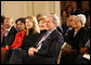 President George W. Bush, Mrs. Laura Bush, Jenna Bush and Secretary of State Condoleezza Rice join the East Room audience in listening to The Temptations Tuesday, Feb. 12, 2008, during a celebration of African American History Month. White House photo by Eric Draper