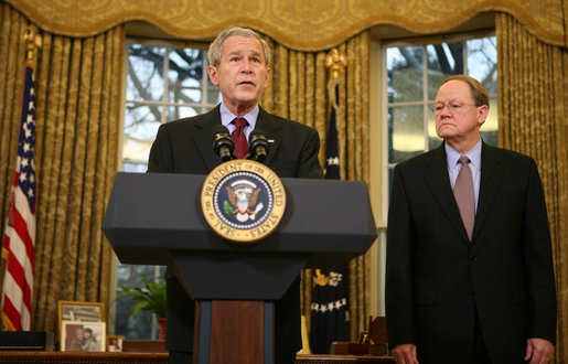 With Michael McConnell, Director of National Intelligence, looking on, President George W. Bush delivers a statement on the Protect America Act Wednesday, Feb. 13, 2008, in the Oval Office of the White House. Said the President, "It is time for Congress to ensure the flow of vital intelligence is not disrupted. It is time for Congress to pass a law that provides a long-term foundation to protect our country. And they must do so immediately." White House photo by Joyce N. Boghosian