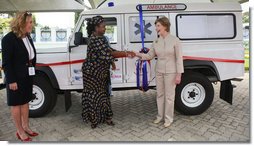 Mrs. Laura Bush and Mrs. Salma Kikwete, First Lady of Tanzania, exchange handshakes after Mrs. Bush presented Mrs. Kikwete with keys to an ambulance Sunday, Feb. 17, 2008, during her visit to Dar es Salaam. The ambulance will be donated to Sokoine Regional Hospital and will be used in the Lindi Region, one of the poorest and neediest in the country. The donation was a result of a joint visit to the hospital by Mrs. Kikwete and Pam White, left, USAID Mission Director. White House photo by Shealah Craighead