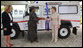 Mrs. Laura Bush and Mrs. Salma Kikwete, First Lady of Tanzania, exchange handshakes after Mrs. Bush presented Mrs. Kikwete with keys to an ambulance Sunday, Feb. 17, 2008, during her visit to Dar es Salaam. The ambulance will be donated to Sokoine Regional Hospital and will be used in the Lindi Region, one of the poorest and neediest in the country. The donation was a result of a joint visit to the hospital by Mrs. Kikwete and Pam White, left, USAID Mission Director. White House photo by Shealah Craighead