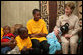 A young girl rests her head on Mrs. Laura Bush’s lap Sunday, Feb. 17, 2008, as she visits with orphans and caretakers in the Living Room of the WAMA Foundation, a non-profit organization founded by Salma Kikwete, First Lady of Tanzania. White House photo by Shealah Craighead