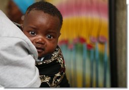 A young Tanzanian child is awed by the camera during a visit by Mrs. Laura Bush Sunday, Feb. 17, 2008, to the WAMA Foundation in Dar es Salaam. The foundation is a non-profit organization founded by Salma Kikwete, First Lady of Tanzania, with a focus on development by improving women’s social and economic status by redefining gender roles and creating more opportunities for the development of women and children. White House photo by Shealah Craighead