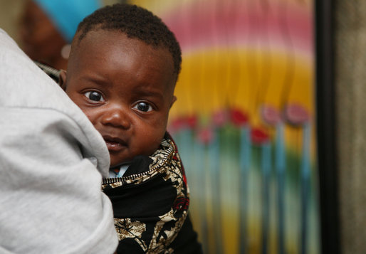 A young Tanzanian child is awed by the camera during a visit by Mrs. Laura Bush Sunday, Feb. 17, 2008, to the WAMA Foundation in Dar es Salaam. The foundation is a non-profit organization founded by Salma Kikwete, First Lady of Tanzania, with a focus on development by improving women’s social and economic status by redefining gender roles and creating more opportunities for the development of women and children. White House photo by Shealah Craighead