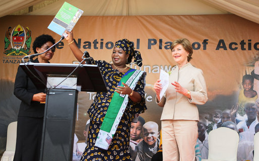 Mrs. Laura Bush applauds as Mrs. Salma Kikwete, First Lady of Tanzania, holds up the National Costed Plan of Action for Most Vulnerable Children, 2007-2010, supported both financially and technically by PEPFAR and UNICEF, during the visit by Mrs. Bush to the WAMA Foundation in Dar es Salaam. White House photo by Shealah Craighead