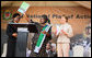 Mrs. Laura Bush applauds as Mrs. Salma Kikwete, First Lady of Tanzania, holds up the National Costed Plan of Action for Most Vulnerable Children, 2007-2010, supported both financially and technically by PEPFAR and UNICEF, during the visit by Mrs. Bush to the WAMA Foundation in Dar es Salaam. White House photo by Shealah Craighead