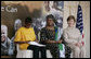 Mrs. Laura Bush and Mrs. Salma Kikwete, First Lady of Tanzania, enjoy Salvation Army Children as they perform on stage Sunday, Feb. 17, 2008, at the WAMA Foundation in Dar es Salaam. The foundation, founded by Mrs. Kikwete, is a non-profit organization focusing on development by improving women’s social and economic status by redefining gender roles and creating more opportunities for the development of women and children. White House photo by Shealah Craighead