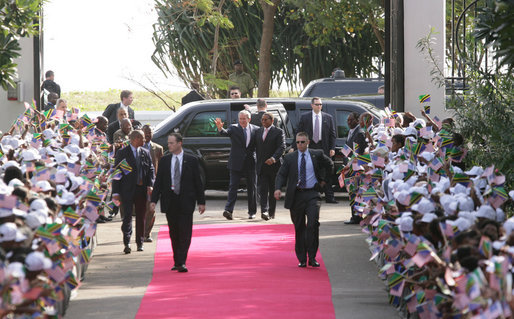 President George W. Bush is greeted by President Jakaya Kikwete of Tanzania, as he arrives at the State House in Dar es Salaam Sunday, Feb. 17, 2008. Hundreds of well-wishers joined the ceremonial welcome cordon to welcome President Bush. White House photo by Chris Greenberg