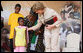 Mrs. Laura Bush pats the back of 7-year-old Zuena Dotto, after she presented Mrs. Bush with a scrapbook during the launch of the National Plan for Action event at the WAMA Foundation Sunday, Feb. 17, 2008, in Dar es Salaam. White House photo by Eric Draper