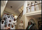 Mrs. Laura Bush and Mrs. Salma Kikwete acknowledge the performance of the Madrasa Salima Choir as they depart Karimjee Hall Sunday, Feb. 17, 2008, after participating in a roundtable discussion on HIV/AIDS. White House photo by Shealah Craighead