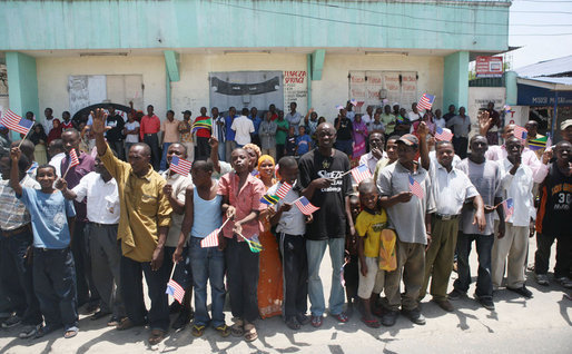 Crowds cheer and wave flags as the motorcade of President George W. Bush and Mrs. Laura Bush arrives Sunday, Feb. 17, 2008, to the Amana District Hospital in Dar es Salaam, Tanzania, where President Bush and Mrs. Bush visited a care and treament clinic. White House photo by Shealah Craighead