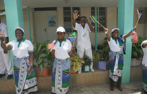 Four women cheer and wave flags upon the arrival President George W. Bush and Mrs. Laura Bush Sunday, Feb. 17, 2008, to the Amana District Hospital in Dar es Salaam, Tanzania, where President Bush and Mrs. Bush visited a patients and staff at the hospital's care and treament clinic. White House photo by Shealah Craighead