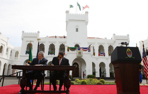 President George W. Bush and President Jakaya Kikwete of Tanzania, sign the Millennium Challenge Compact -- a $698 million dollar compact that is the largest project in the Millennium Challenge Corporation’s history – prior to the start of their joint press availability Sunday, Feb. 17, 2008, at the State House in Dar es Salaam. White House photo by Eric Draper