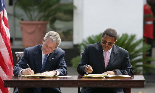 President George W. Bush and President Jakaya Kilwete of Tanzania sign the Millenium Challenge Compact Sunday, Feb. 17, 2008, at the State House in Dar es Salaam, Tanzania. White House photo by Chris Greenberg