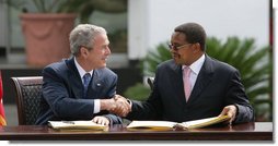 President George W. Bush and President Jakaya Kikwete of Tanzania, shake hands after signing the $698 million Millennium Challenge Compact Sunday, Feb. 17, 2008, in Dar es Salaam. In signing the compact, President Bush said, “We are partners in democracy. We believe that governments ought to respond to the people. We're also partners in fighting disease, extending opportunity and working for peace. Mr. President, I mentioned I was proud to sign, along with the President, the largest Millennium Challenge Account in the history of the United States here in Tanzania. It will provide nearly $700 million over five years to improve Tanzania's transportation network, secure reliable supplies of energy, and expand access to clean and safe water. White House photo by Chris Greenberg