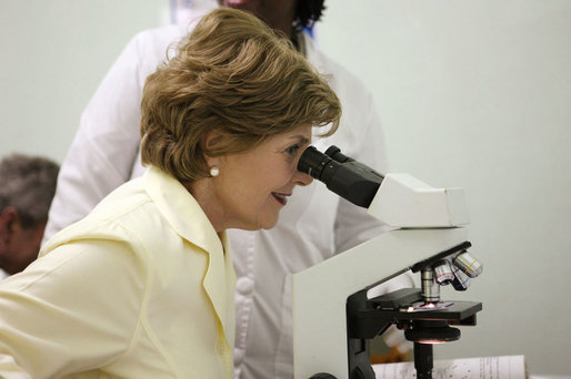 Mrs. Laura Bush views a medical slide thru a microscope Monday, Feb. 18, 2008, during a tour of the Meru District Hospital outpatient clinic in Arusha, Tanzania. White House photo by Eric Draper