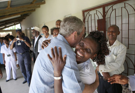 President George W. Bush embraces a hospital staff member Monday, Feb. 18, 2008, during a tour of the outpatient facility at the Meru District Hospital in Arusha, Tanzania. White House photo by Eric Draper