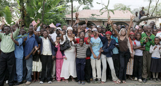 Crowds cheer and wave flags as the motorcade of President George W. Bush and Mrs. Laura Bush travel Monday, Feb. 18, 2008 to the Meru District Hospital in Arusha, Tanzania. White House photo by Shealah Craighead