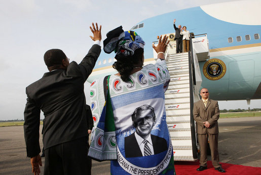 Tanzanian President Jakaya Kikwete and first lady Salma Kikwete, wearing a blouse imprinted with a likeness of President George W. Bush, wave farewell to President Bush and Mrs. Laura Bush Tuesday, Feb. 19, 2008 at Julius Nyerere International Airport in Dar es Salaam, Tanzania. White House photo by Eric Draper