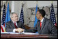 President George W. Bush and Rwanda President Paul Kagame shake hands after signing a Bilateral Investment Treaty Tuesday, Feb. 19, 2008, at the Presidency in Kigali, Rwanda. White House photo by Shealah Craighead