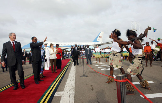 President George W. Bush and President Jakaya Kikwete of Tanzania are joined by Salma Kikwete, spouse of President Jakaya Kikwete, and Mrs Laura Bush as they watch a cultural performance Tuesday, Feb. 19, 2008, at the Julius Nyerere International Airport in Dar es Salaam, Tanzania before their departure to Kigali, Rwanda. White House photo by Eric Draper