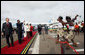 President George W. Bush and President Jakaya Kikwete of Tanzania are joined by Salma Kikwete, spouse of President Jakaya Kikwete, and Mrs Laura Bush as they watch a cultural performance Tuesday, Feb. 19, 2008, at the Julius Nyerere International Airport in Dar es Salaam, Tanzania before their departure to Kigali, Rwanda. White House photo by Eric Draper