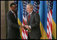 President George W. Bush and President Paul Kagame shake hands Tuesday, Feb. 19, 2008, following the dedication and ribbon cutting ceremony to formally open the new United States Embassy in Kigali, Rwanda. White House photo by Chris Greenberg