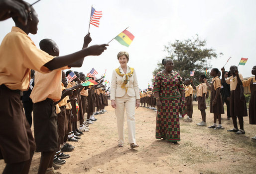 Mrs. Laura Bush and Ghana first lady Mrs. Theresa Kufuor, are greeted by singing students waving flags, on their arrival to Mallam D/A Primary School, Wednesday, Feb. 20, 2008 in Accra, Ghana. White House photo by Shealah Craighead