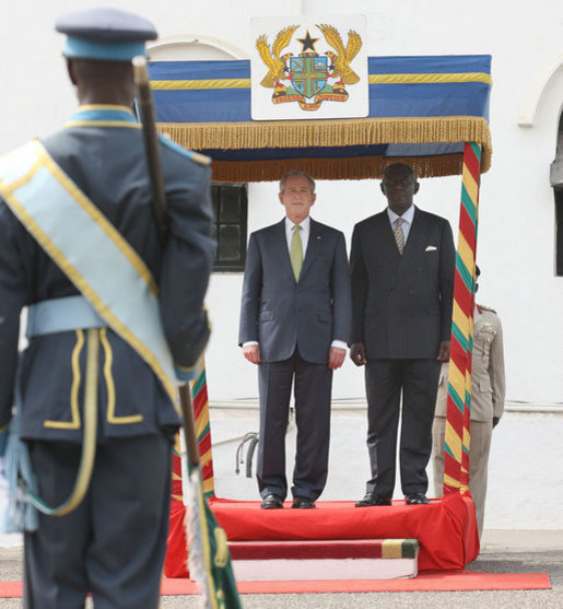 President George W. Bush stands with Ghana President John Agyekum Kufuor during the official welcome to Osu Castle, Wednesday, Feb. 20, 2008 in Accra, Ghana. White House photo by Eric Draper