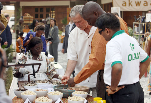 President George W. Bush looks over a table of local food items Wednesday, Feb. 20, 2008, during his visit to the International Trade Fair Center in Accra, Ghana. White House photo by Eric Draper