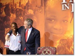 President George W. Bush embraces a student Thursday, Feb. 21, 2008, during an education roundtable at the University of Liberia in Monrovia, Liberia. White House photo by Eric Draper