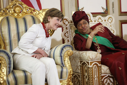 Mrs. Laura Bush listens to Liberian President Ellen Johnson-Sirleaf Thursday, February 21, 2008, in Monrovia, Liberia, during a gowning and investiture ceremony in honor of President Bush, Mrs. Bush and Secretary Condoleezza Rice. White House photo by Shealah Craighead